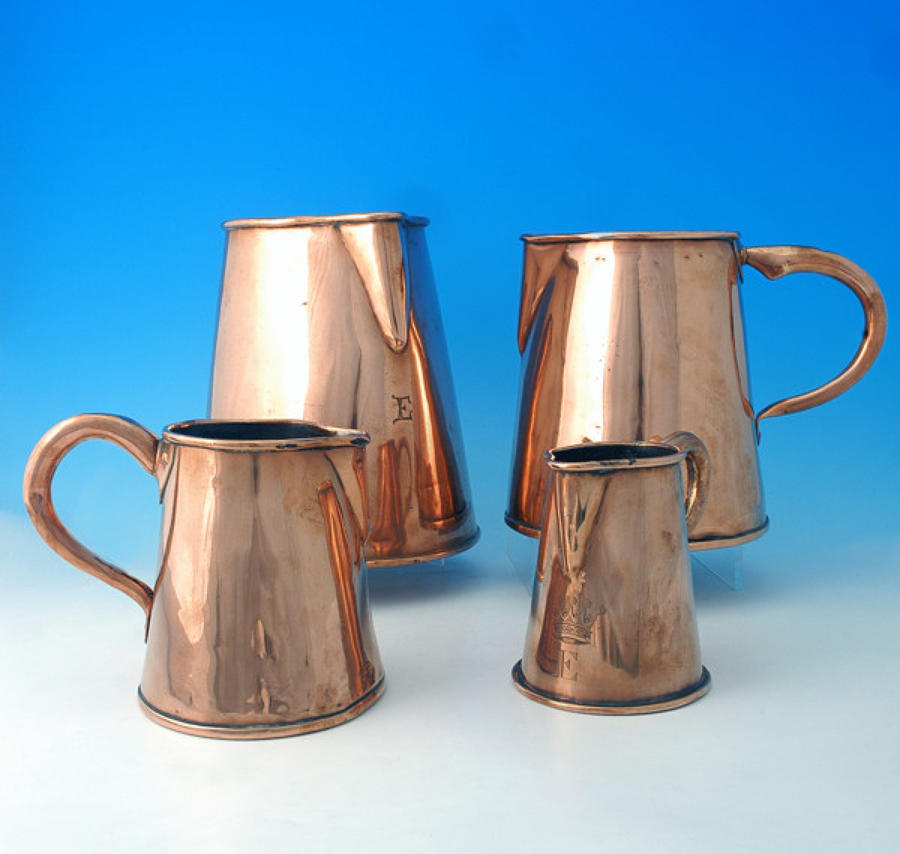 Set of four graduating Copper Jugs. English C1800