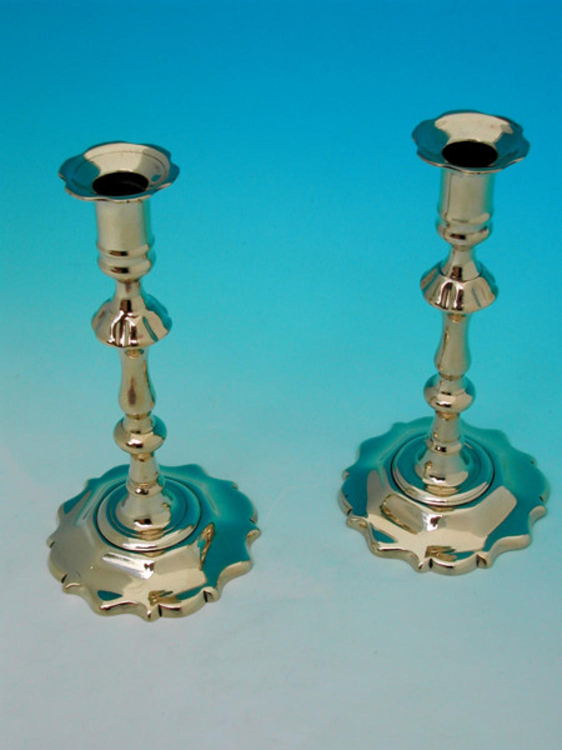 A pair of 18thc Brass Petalbase Candlesticks. English C1745 - 65